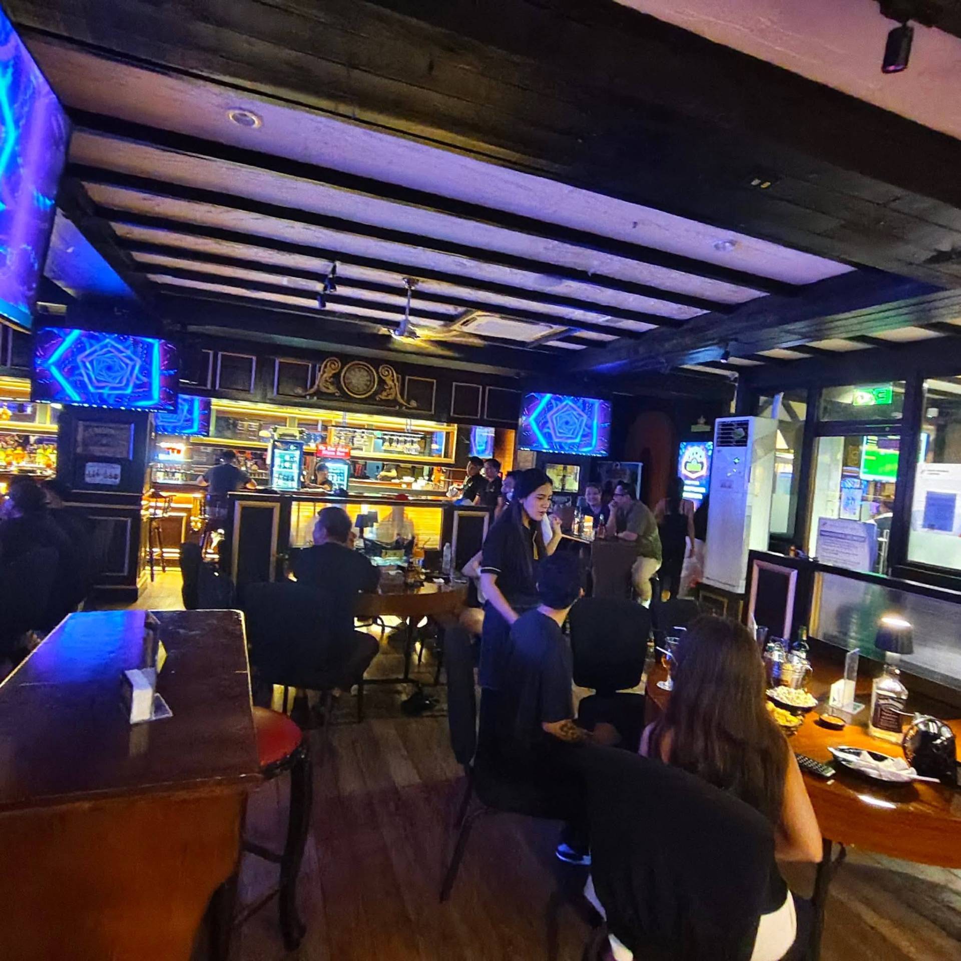 Inside Rob's Gastropub — warm wood interior with bar and TVs